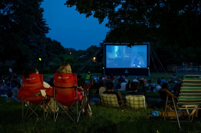 Minneapolis residents lounging during movie night at Dickman Park
