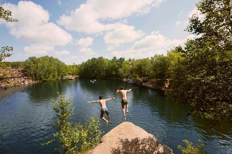 Cliff jumpers leap into a swimming hole at Quarry Park and Nature Preserve in St. Cloud, one of many swimming holes in Minnesota