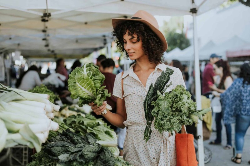 A woman checks out produce at one of many farmers markets in Minnesota